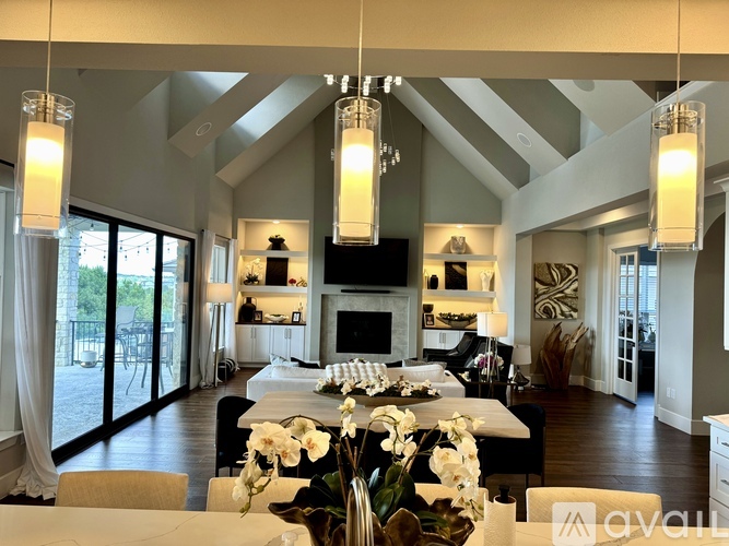 A modern living room with a fireplace and a dining table set for a meal.