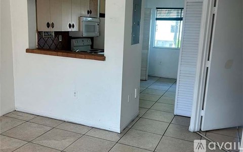 A kitchen with a microwave, toaster, and oven on a counter.