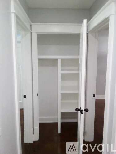 A white door is open to a hallway.