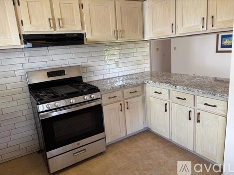 A kitchen with a stove and cabinets.