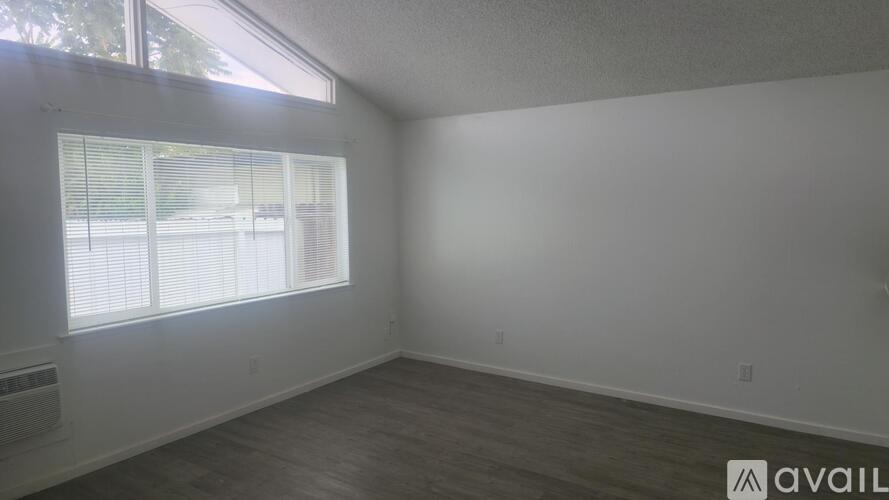 A room with a window and a sign that says "available".