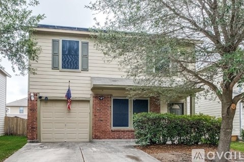 A house with a garage and an American flag hanging on the wall.
