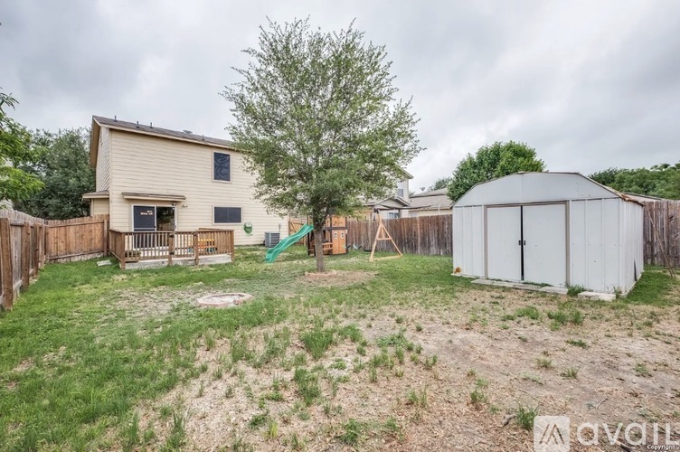 A backyard with a playground and a shed.