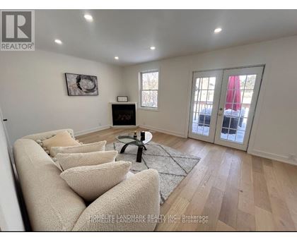 A living room with a couch, coffee table, and a window.