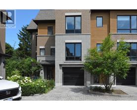 A modern two-story house with a garage and a tree in front.
