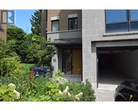 A modern house with a garage and a garden in front.