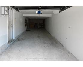 A spacious garage with a concrete floor and white walls.