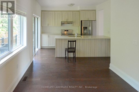 A kitchen with a counter and a chair.
