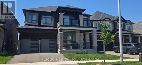 A modern house with a large front yard is for sale.