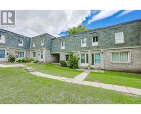 A row of houses with a grassy front yard.