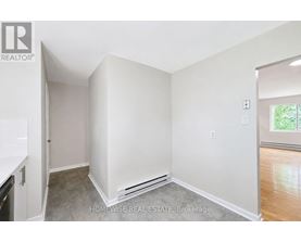 A white bedroom with a window and a door.