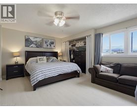 A bedroom with a large bed and a couch.