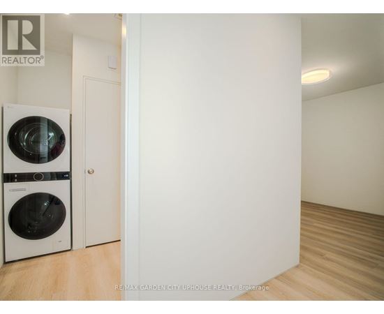 A white laundry room with a washer and dryer.