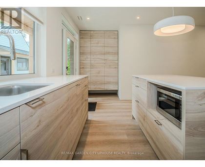 A modern kitchen with wooden cabinets and a white countertop.