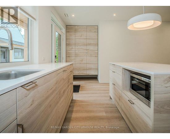 A modern kitchen with wooden cabinets and a white countertop.