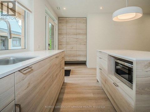A modern kitchen with wooden cabinets and a white countertop.