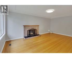 A room with a fireplace and wooden floors.