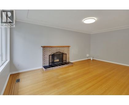 A room with a fireplace and wooden floors.