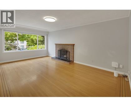 A room with a fireplace and a large window.