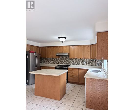 A kitchen with wooden cabinets and a white counter top.