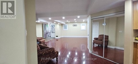 A living room with a couch and a chair in it.