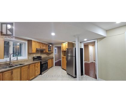 A kitchen with wooden cabinets and a black stove top oven.