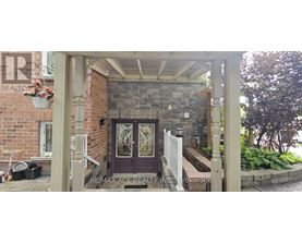 A house entrance with a glass door and a sign that says RE/MAX Ace Realty.