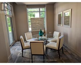 A dining room with a glass table and chairs.