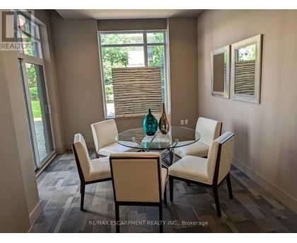 A dining room with a glass table and chairs.