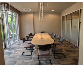 A conference room with a long table and chairs.