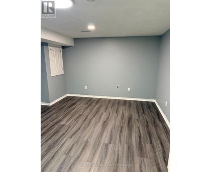 A room with grey walls and wooden flooring.
