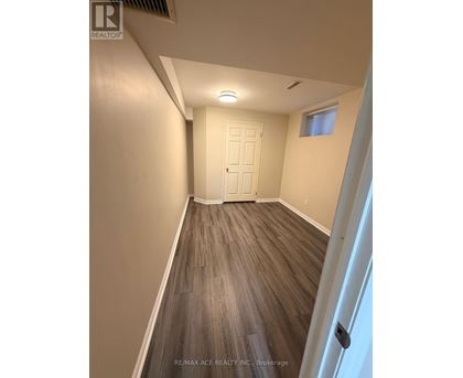 A room with a white door and a window with a white wall.