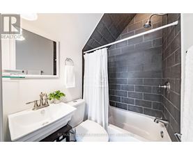 A bathroom with a white sink and a white towel.