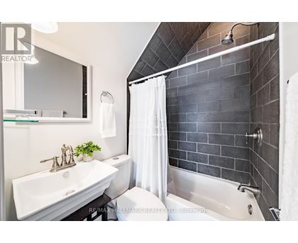 A bathroom with a white sink and a white towel.
