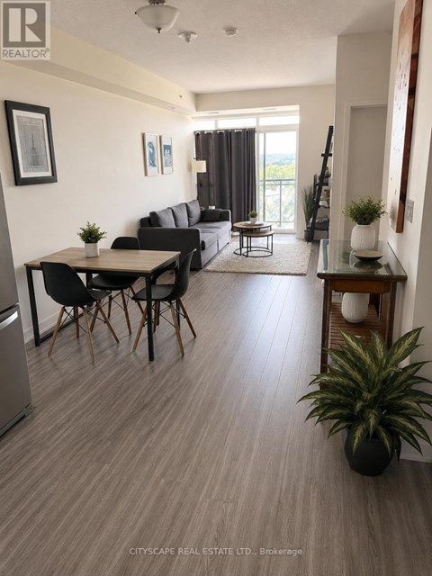 A living room with a dining table and chairs.
