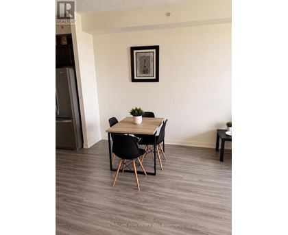 A dining room with a wooden table and chairs.