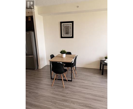 A dining room with a wooden table and chairs.
