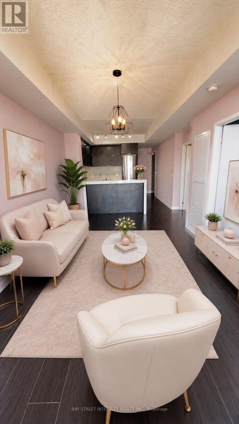 A living room with a white sofa, a white armchair, and a coffee table with a plant on it.