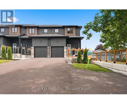 A large, modern house with a grey exterior and a black garage door.