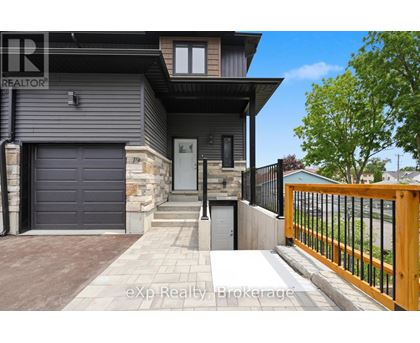 A modern house with a grey garage door and a black gate.