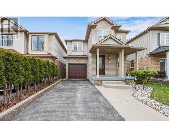 A large, well-maintained house with a driveway in front.