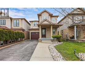 A large, well-maintained house with a driveway and a garage.