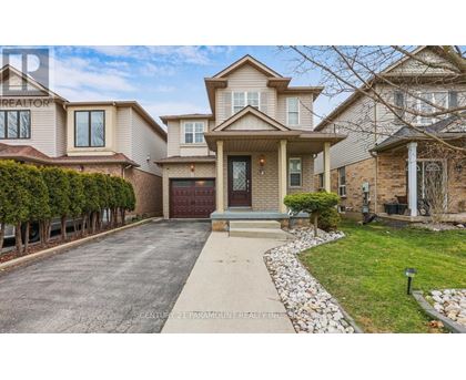 A large, well-maintained house with a driveway and a garage.