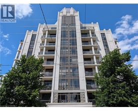A tall residential building with balconies and windows.