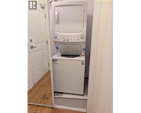 A white oven and microwave are installed in a kitchen.