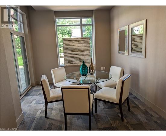 A dining room with a glass table and chairs.