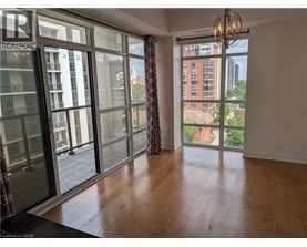 A room with a large window and a chandelier.