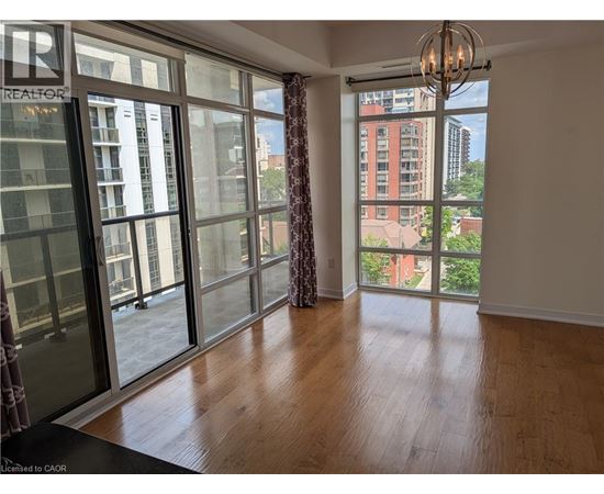 A room with a large window and a chandelier.