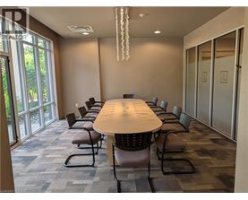 A conference room with a long table and chairs.