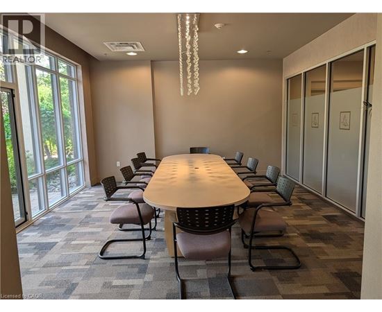 A conference room with a long table and chairs.